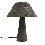 Concrete table lamp with a textured design on a white background