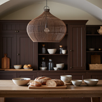 rattan ceiling lighjt in Kitchen with wooden table, bread, and bowls in a warm-toned room.