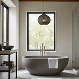 Modern uk bathroom with a freestanding bathtub, window, and rattan pendant light.