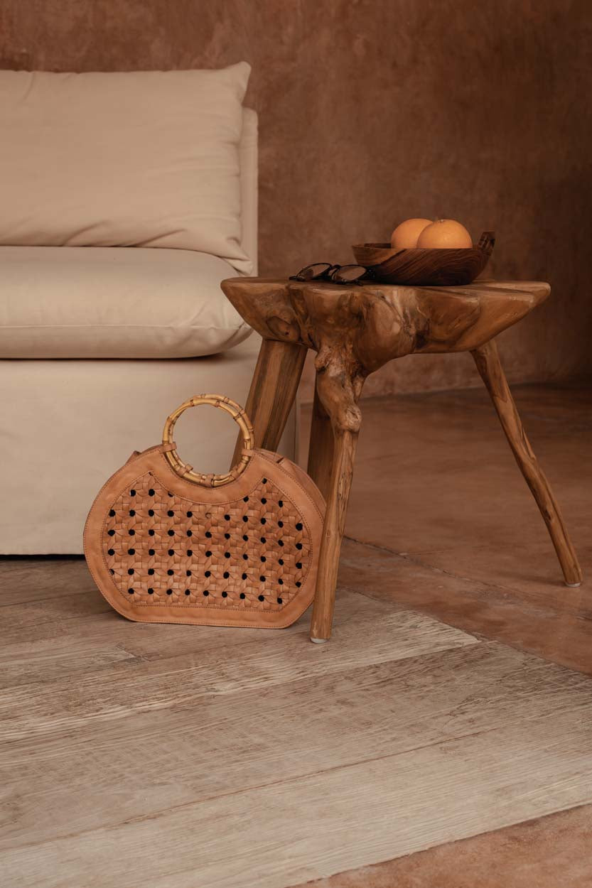 rattan and bamboo on a wooden floor with a wooden side table in an earthy living room
