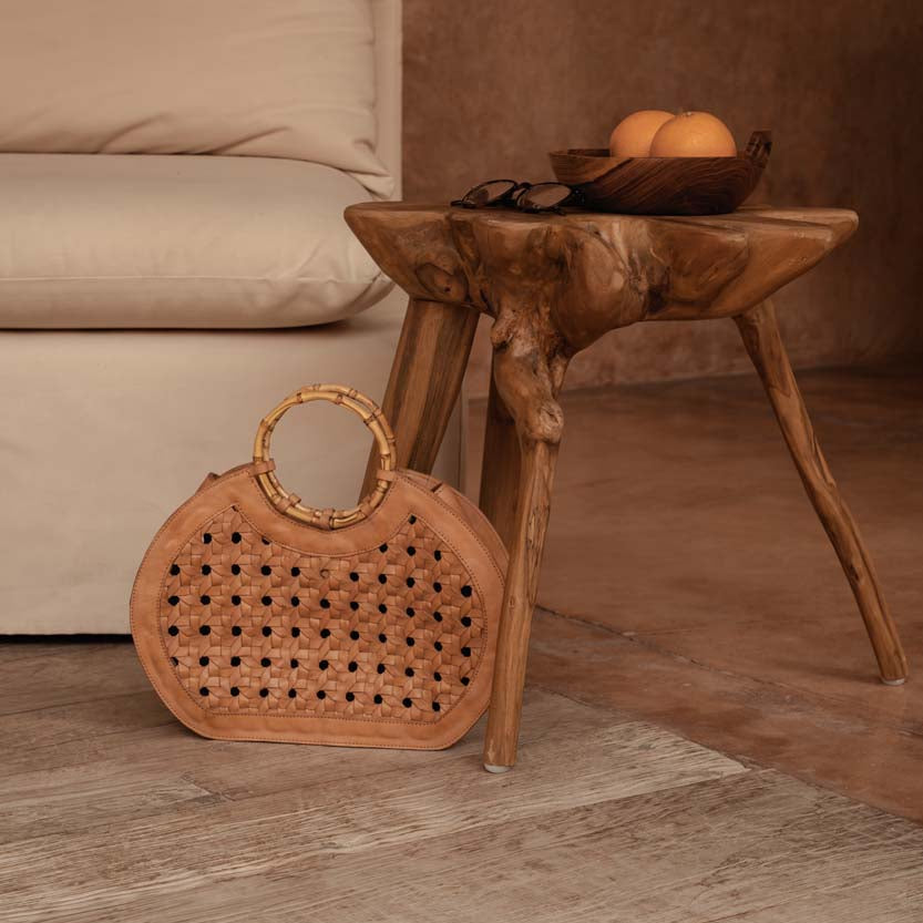 rattan and bamboo on a wooden floor with a wooden side table in an earthy living room