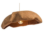 A unique pendant light shaped like a textured brown beret, with a warm glowing light bulb visible inside, suspended by a thin wire against a solid white background.
