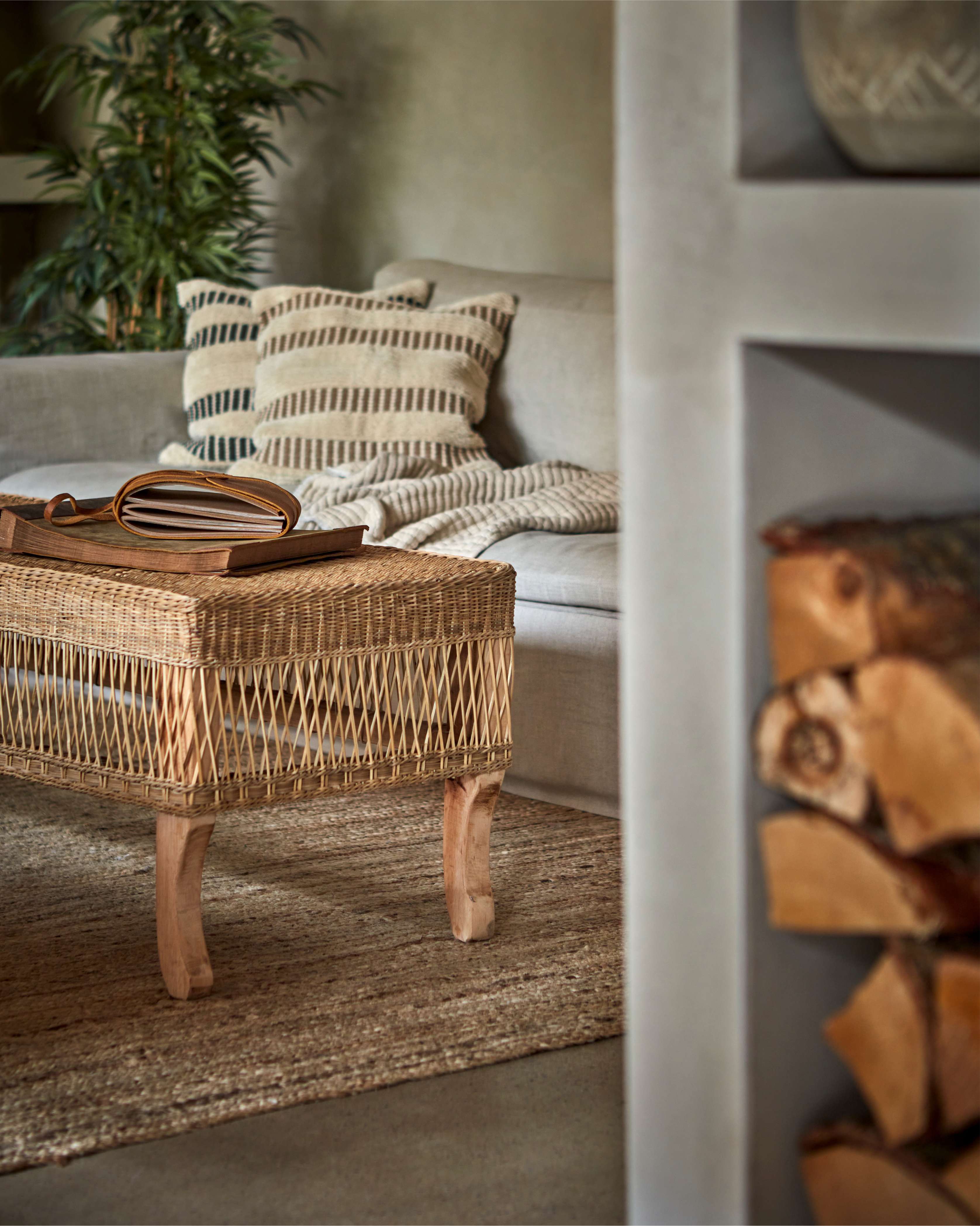 Boucle Stripe Cotton Cushion Covers on beige sofa, rattan coffee table and large palm