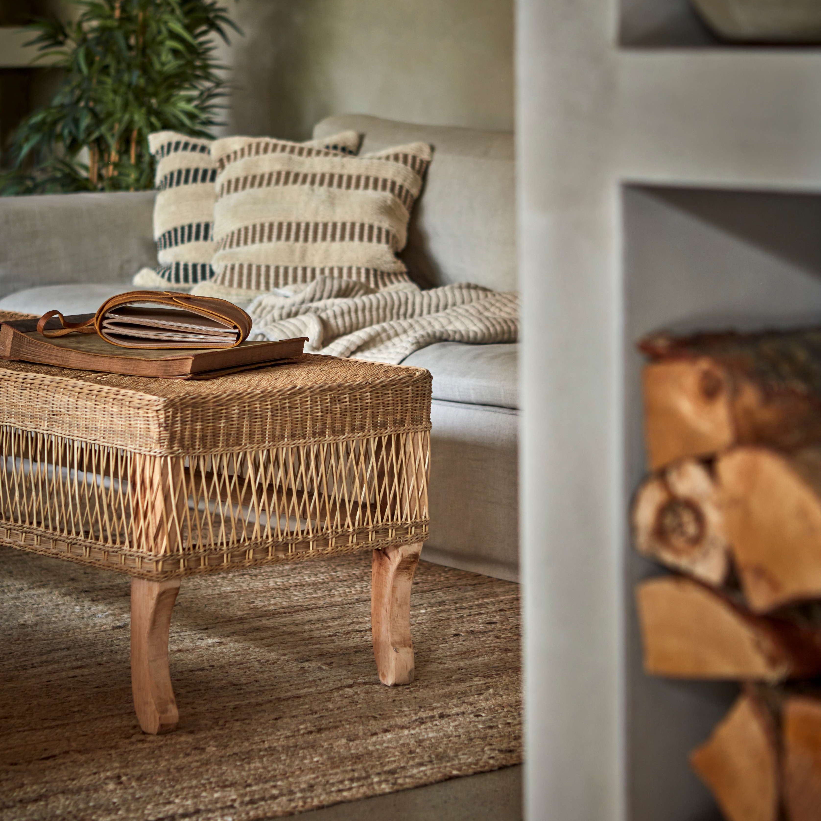 Boucle Stripe Cotton Cushion Covers on beige sofa, rattan coffee table and large palm