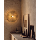 Large round brass Wall light plate with warm white bulb in dining room