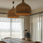 double large light rattan wicker dome light shade over long dining table and chairs
