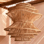 Woven wicker rattan pendant light hanging from a wooden ceiling
