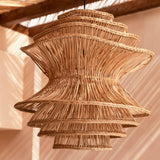 Woven wicker rattan pendant light hanging from a wooden ceiling