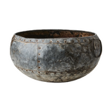 Vintage-style metal bowl with rivets on a white background