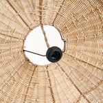 Close-up of a woven wicker rattan large lampshade with a black light bulb holder.