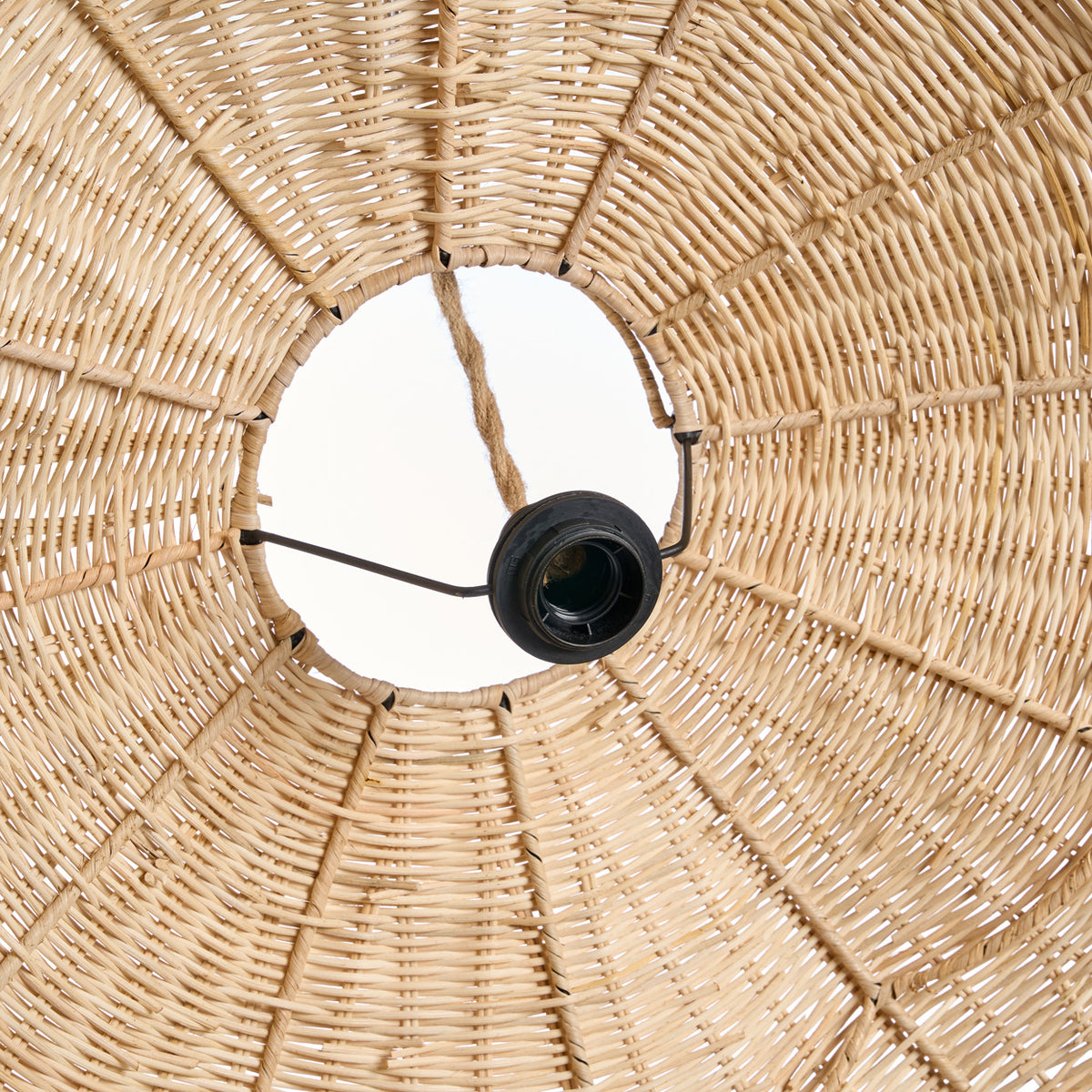 Close up of a woven wicker rattan large lampshade with a black light bulb holder.