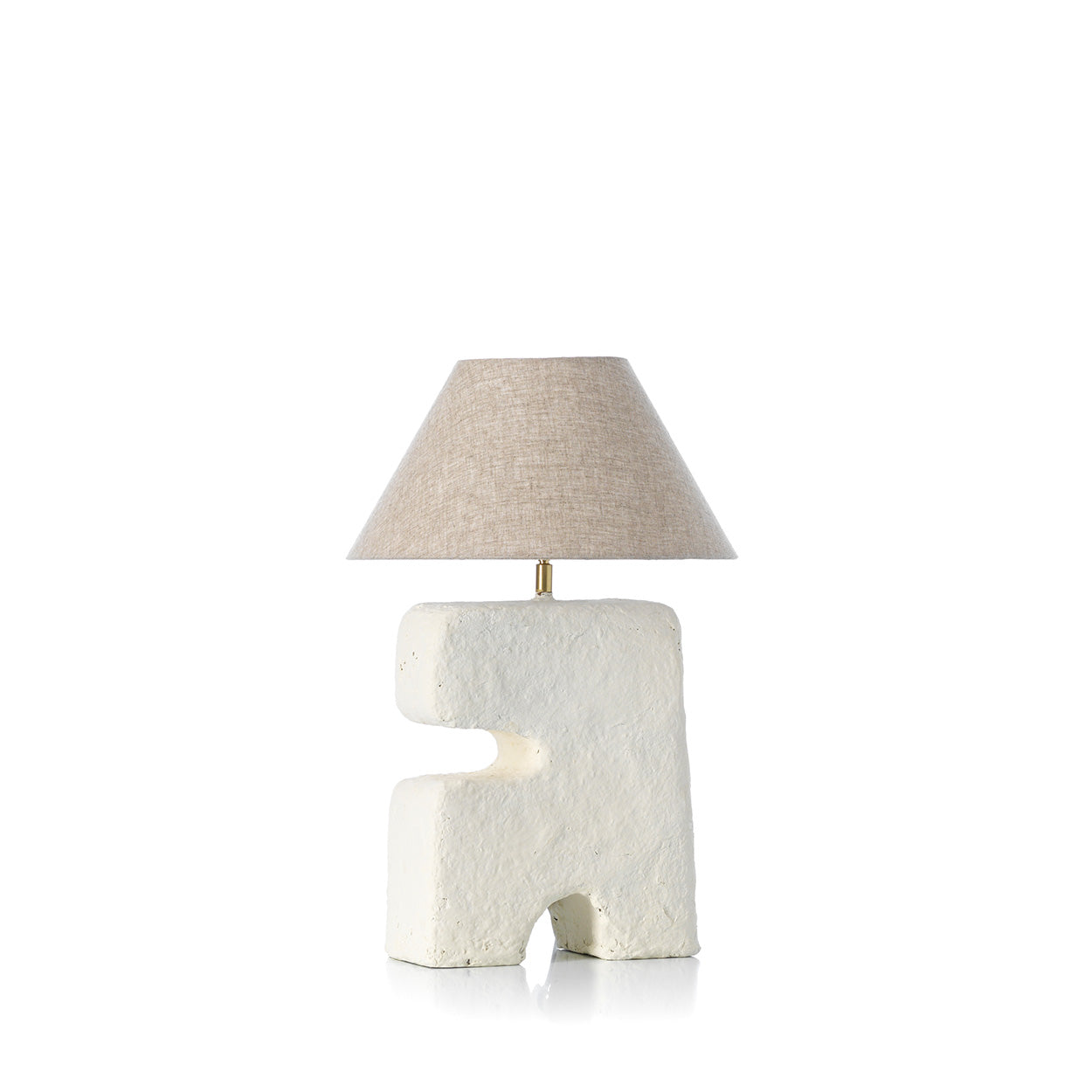 Table lamp with textured white base and beige lampshade on a white background
