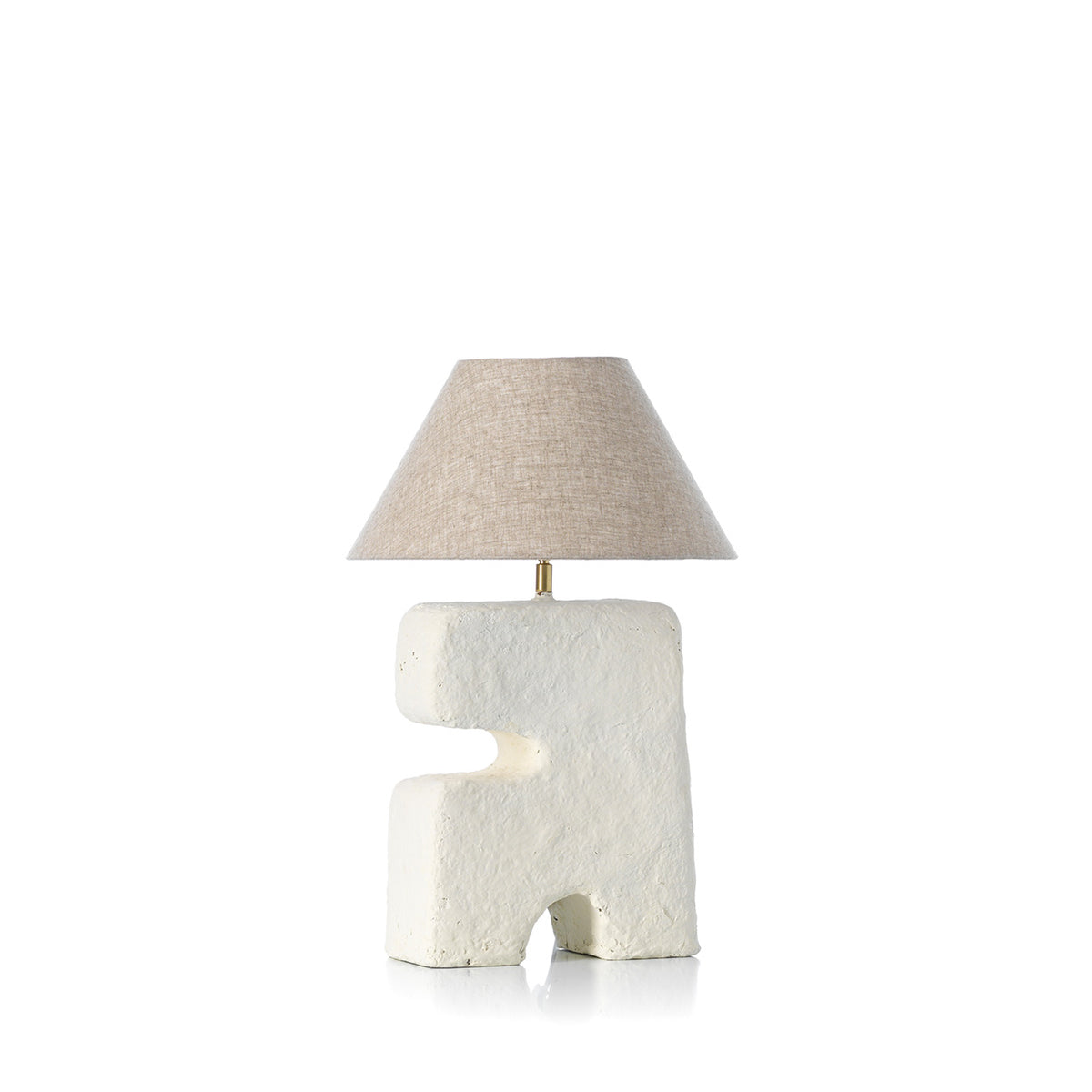 Table lamp with textured white base and beige lampshade on a white background