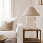 Large Architectural Table Lamp on Wooden Shelved Side Table and Cream Beige Sofa