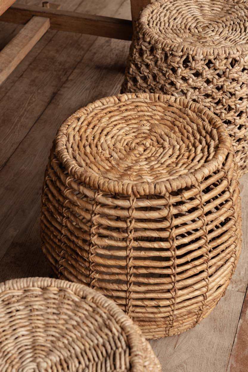 Woven seagrass and rattan stools on a wooden floor