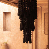 Black Cotton tiered chandelier in rustic room