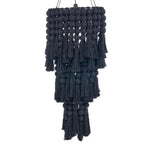 Black cotton linen and tassel hanging pendant light on a white background