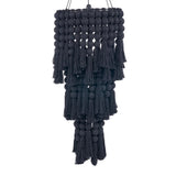 Black cotton linen and tassel hanging pendant light on a white background