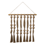Decorative wall hanging with braided ropes and tassels on a white background