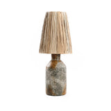 Table lamp with textured base and natural raffia  beige shade on a white background