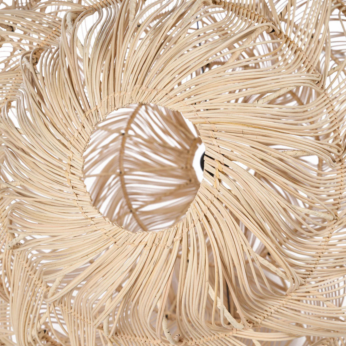 Close up of a beige woven rattan  lampshade with a circular design.