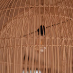 Close-up of a woven rattan lampshade with a blurred background