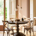 garden Dining area with a round wooden table and chairs in a well-lit room.