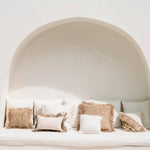 boho rustic neutral cushions on a day bed with rattan wall lights