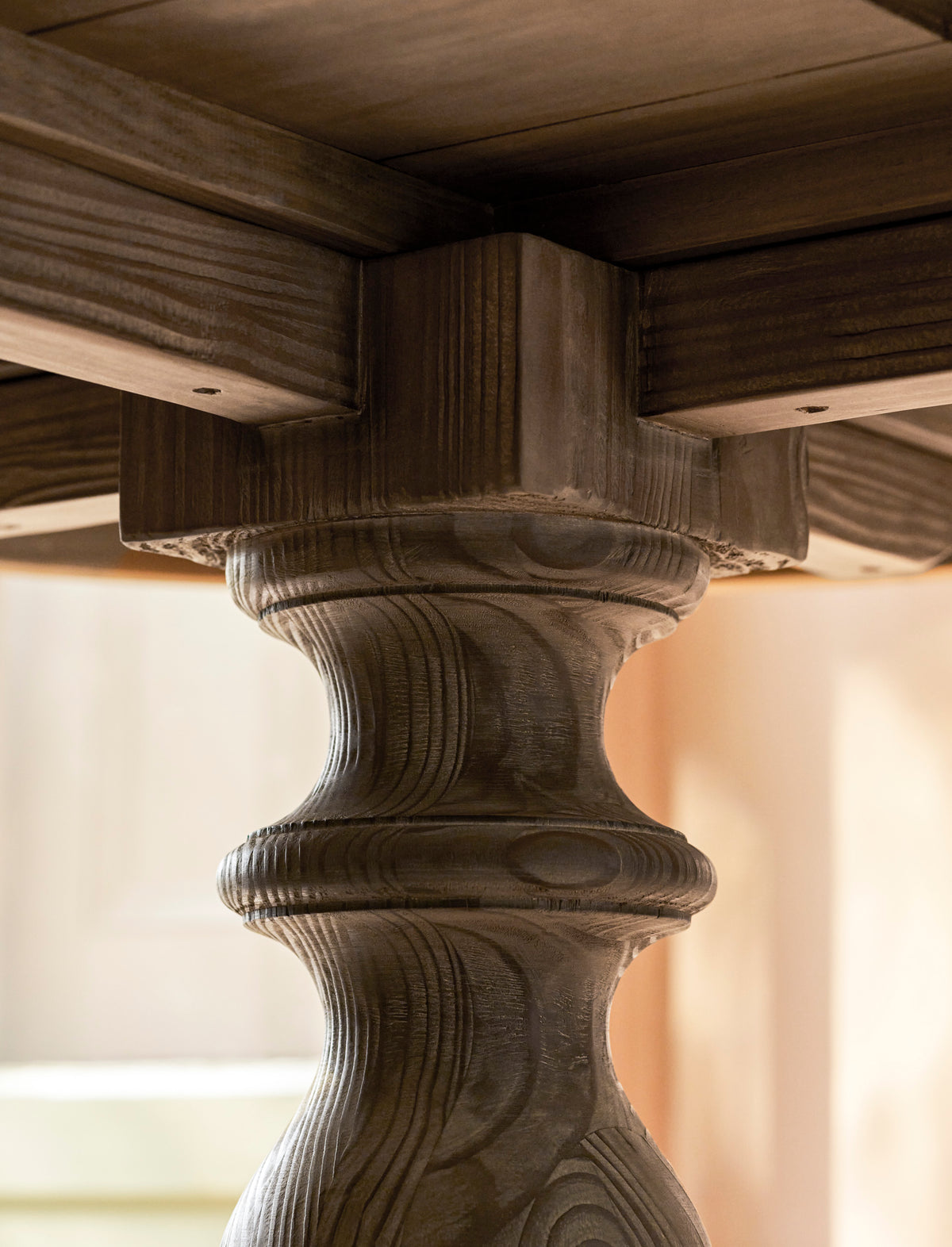 Close up of a wooden table leg with wood grain