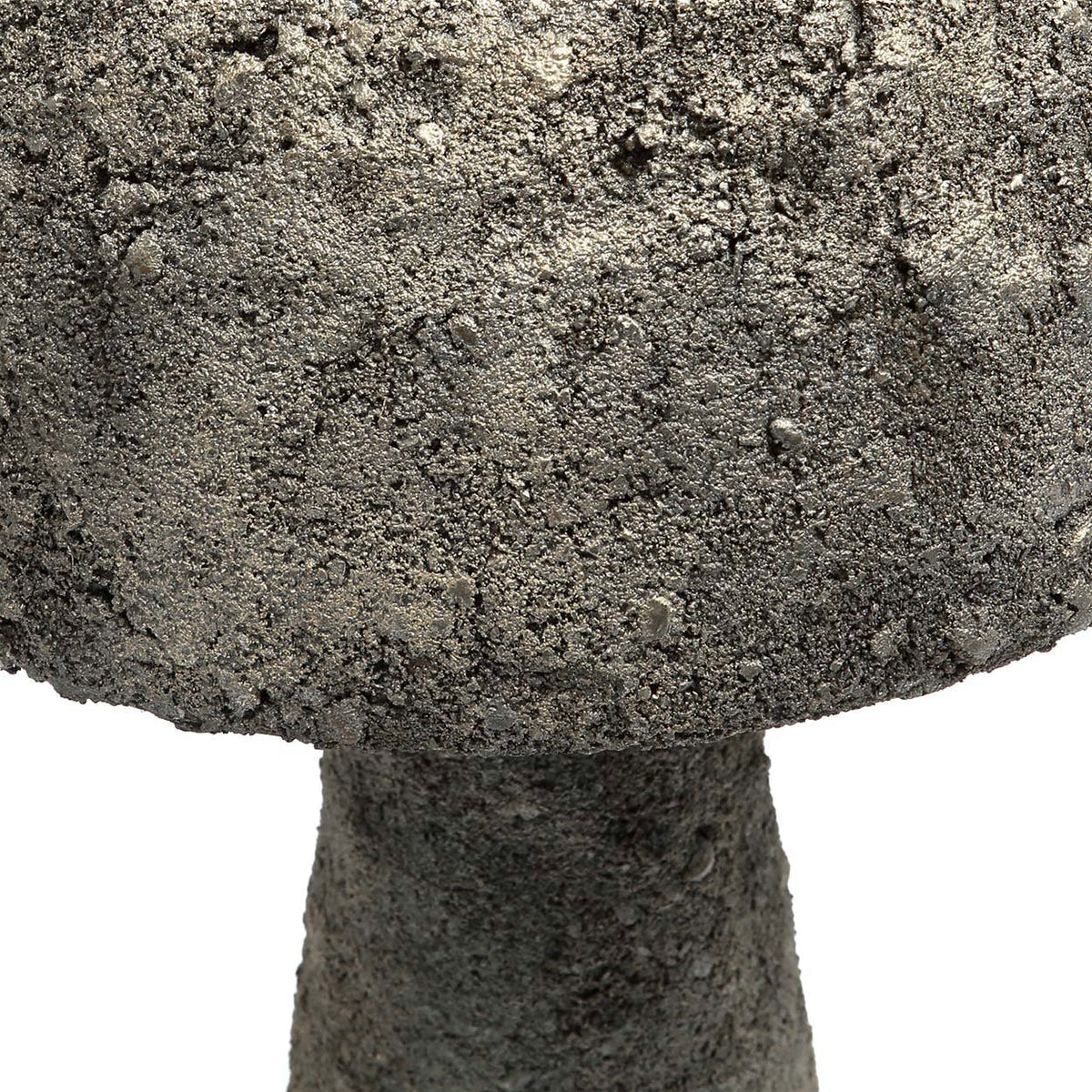 Close-up of a textured stone mushroom sculpture on a white background