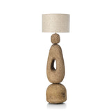 Floor standard lamp with a textured base and linen shade on a white background