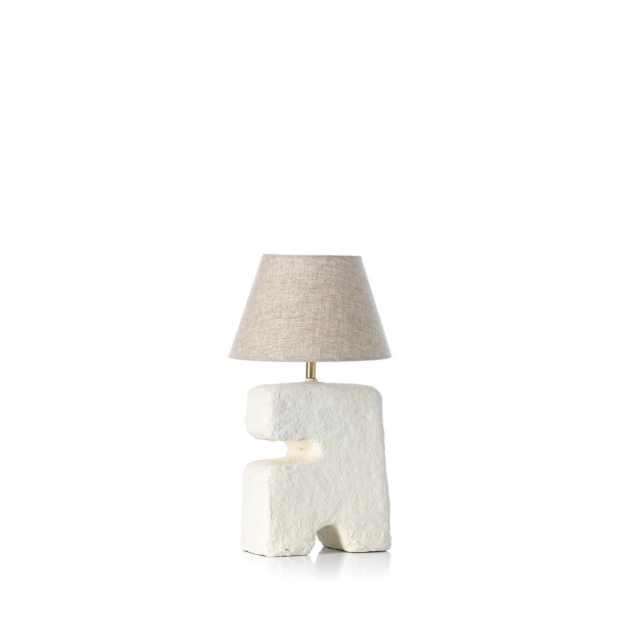 Table lamp with a textured base and beige lampshade on a white background