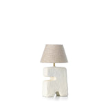 Table lamp with a textured base and beige lampshade on a white background